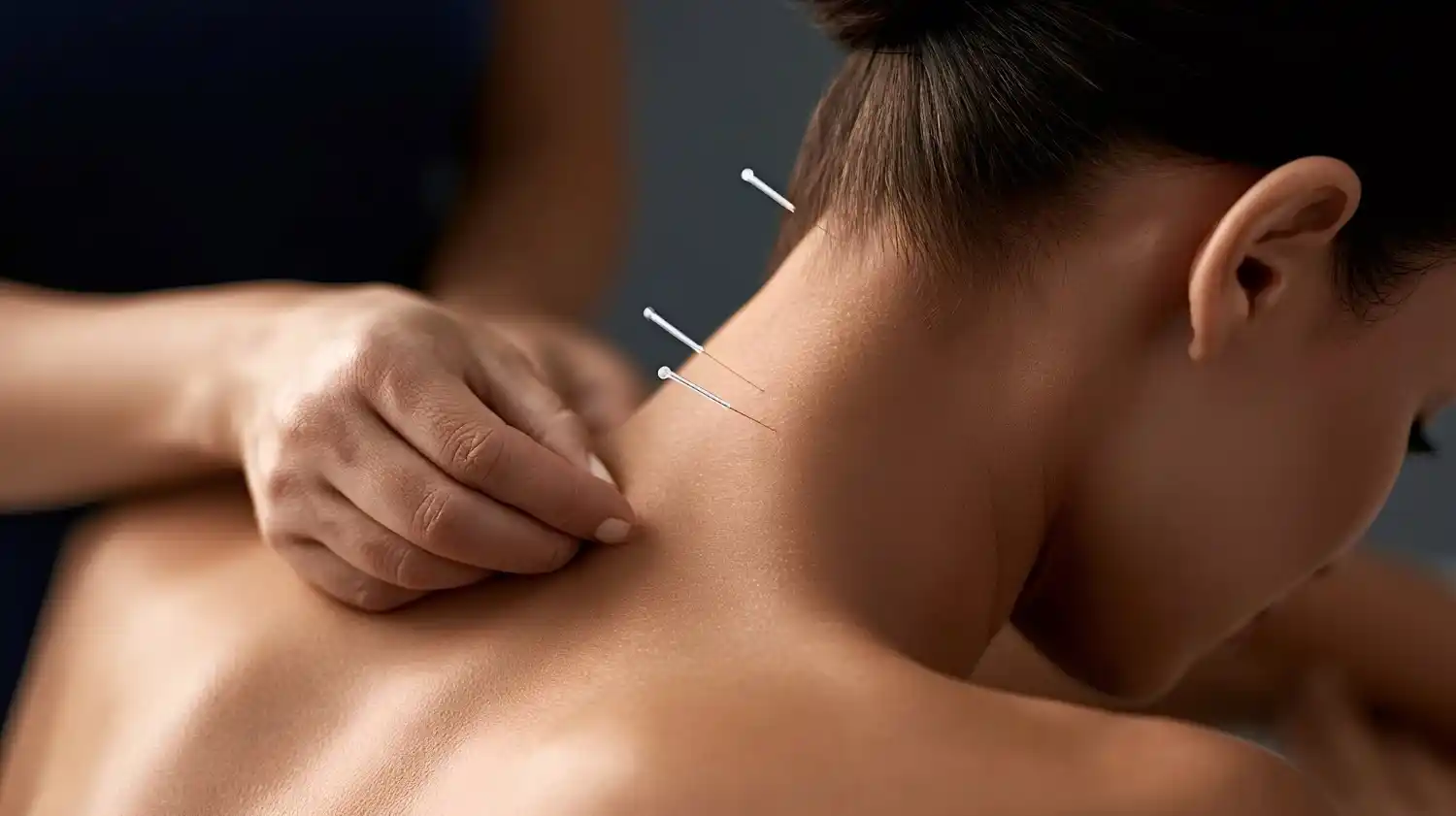 Acupuncture practitioner assessing a patient before treatment