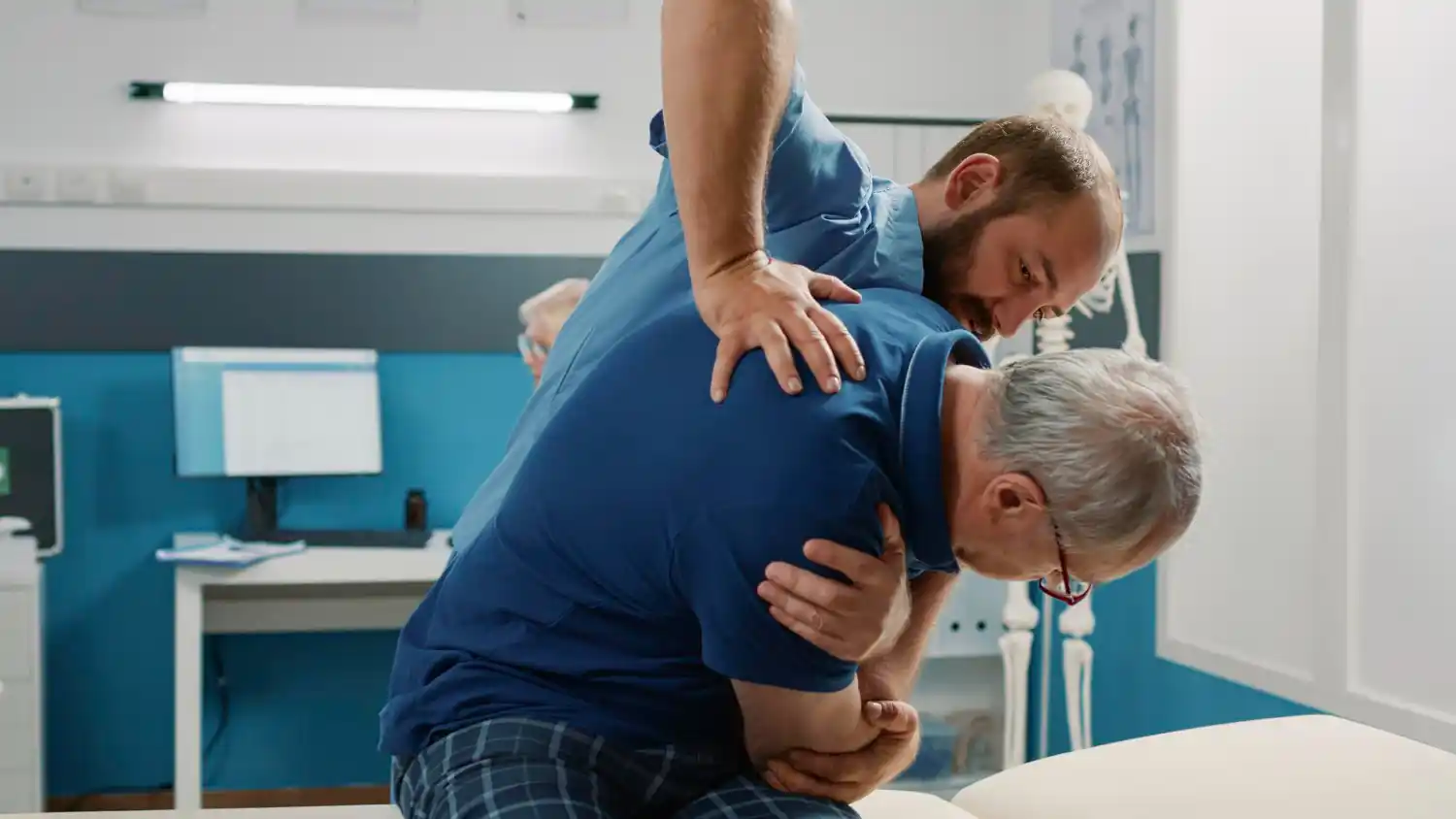 Physiotherapist helping a patient with back rehabilitation exercises